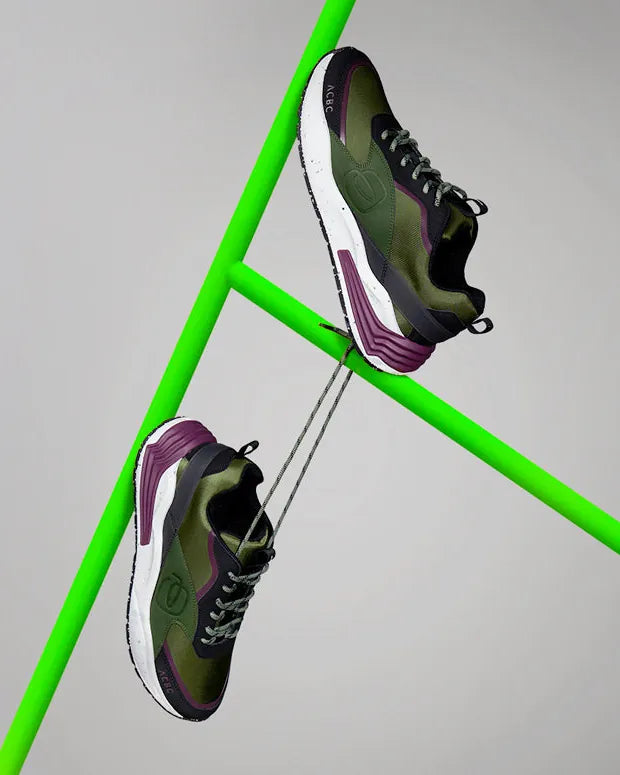 Corner 2.0 sneakers hanging from a green frame