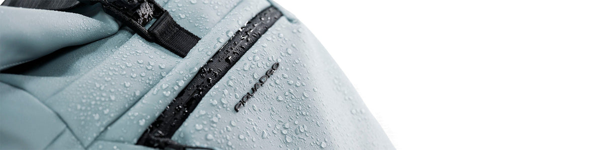 Water drops on the water-resistant fabric of a Piquadro backpack