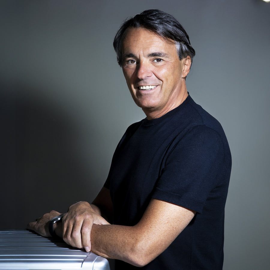 Marco Palmieri in front of the Piquadro logo